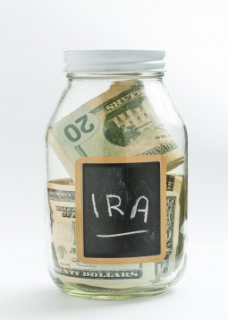 Jar with money in it and a chalkboard label with I.R.A. written on it
