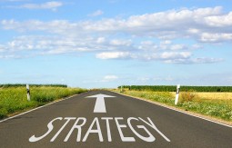 An arrow in the road pointing forward with the word Strategy